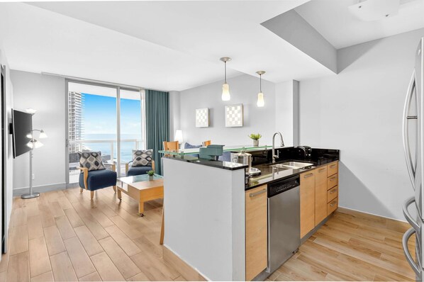 A modern kitchen with a central island, wooden cabinets, and a stainless steel dishwasher.