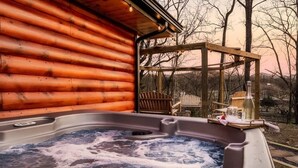 A hot tub with a wooden exterior and a glass enclosure.