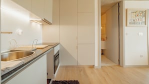 A modern kitchen with a built-in oven, a stainless steel sink, and a wooden countertop. - Amazing Design Garden by Vacationy (Vila Nova de Gaia)