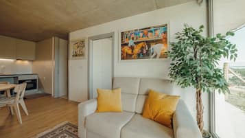 Deluxe Apartment, Garden View | Living area | TV