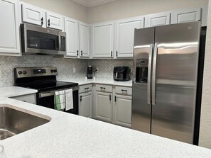 Coffee/tea maker, fridge, microwave, oven