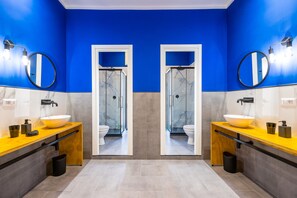 A modern bathroom with two sinks, a large mirror, and a shower enclosure. - The Place :: Designer Apartment Near the Main Train Station (Napoli)