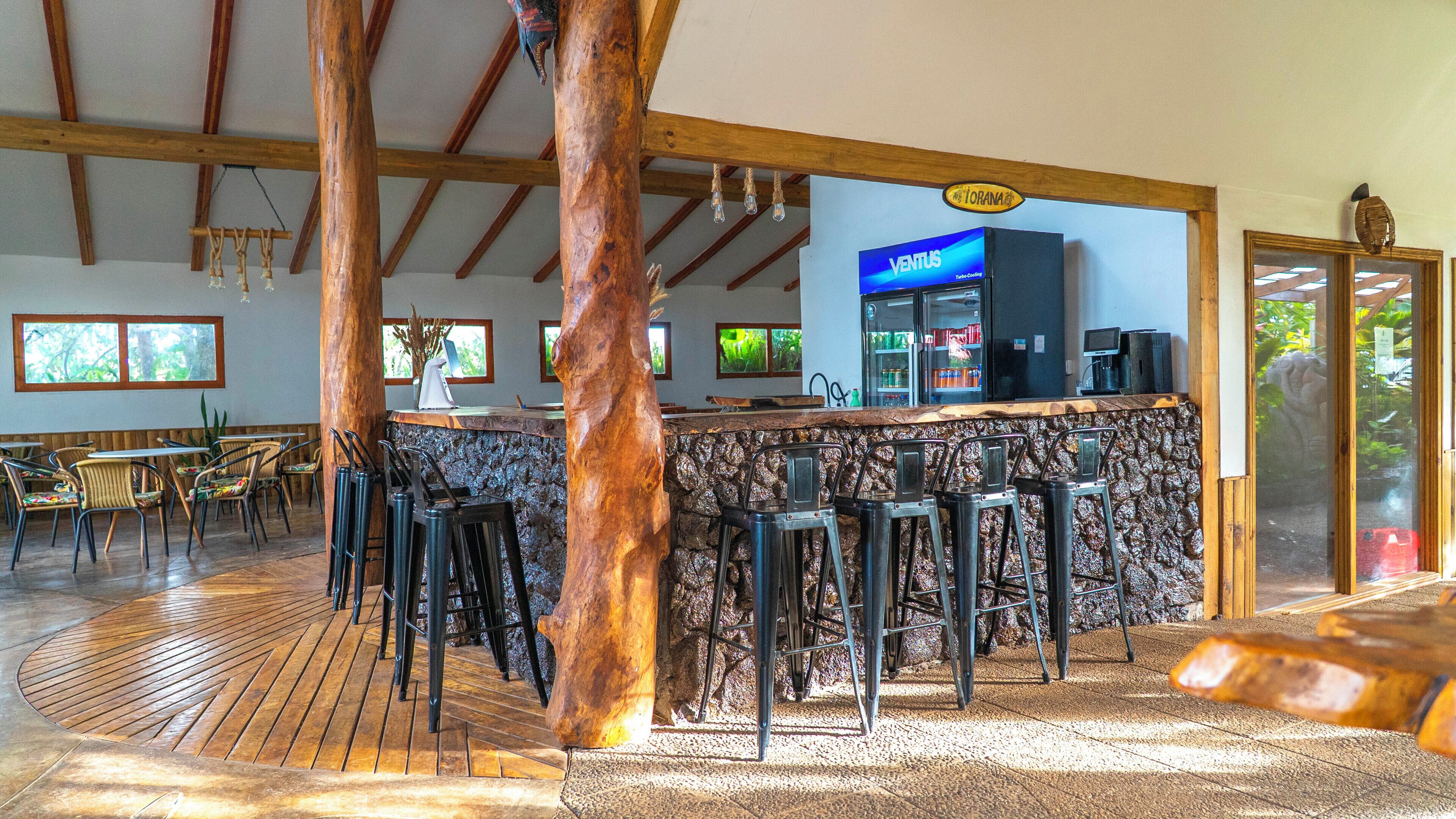 A bar area with stools, a counter, and a sign for 'VENTUS'.