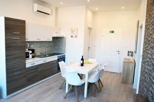 Comfort Apartment | Private kitchen | Full-size fridge, stovetop, dishwasher, electric kettle