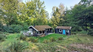 Two small cabins with a deck, surrounded by dense forest. - 2 bedroom beautiful home in Höör (Höör)