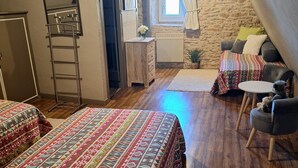 A cozy room with two beds, a small table, a chair, and a window with curtains. - Charming Gîte in Périgord Noir, Close to the Reference Sites of the Dordogne (Archignac)