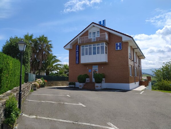A two-story building with a sign reading "Alto Santiago." - Alto Santiago (San Vicente de la Barquera)