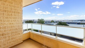 A balcony with a view of a cityscape, including buildings and a clear sky. - Gorgeous apartment in Torrevieja (Torrevieja)