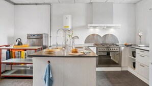 A modern kitchen with a central island, stainless steel appliances, and a red-framed cart. - Amazing home in Vandel with Wi-Fi (Vandel)