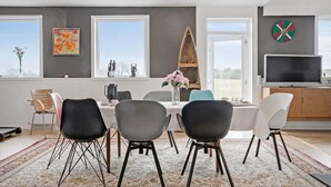 A modern dining room with a large table, black chairs, and a view of the outdoors. - Amazing home in Vandel with Wi-Fi (Vandel)