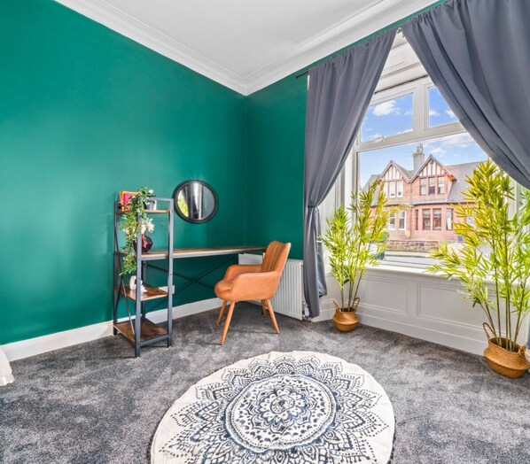 Enjoy a tranquil retreat with a desk, mirror, and comfortable chair, surrounded by a traditional view.