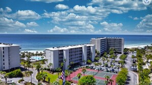 A hotel with a tennis court, a pool, and a view of the ocean. - BIG DISCOUNTS ON ALL MONTHLY RENTALS  - EXLARGE FACING  Emerald Coast Gulf Front (Panama City Beach)