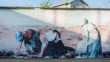 A mural of three figures on a wall.