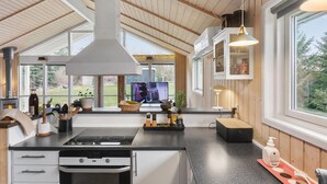 A modern kitchen with a large island, built-in appliances, and a view of the outdoors. - Cozy home in Vordingborg with WiFi (Vordingborg)