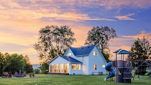 A two-story house with a large deck and a slide in the backyard. - Make the Family Memories Here | Fishing Pond | Indoor Playground | Scenic Views (Nashville)