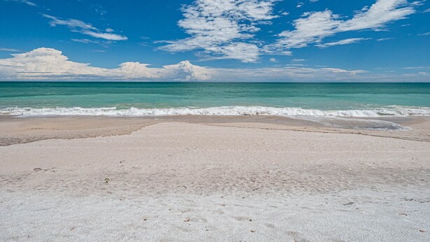 A beach with clear turquoise water and a sandy shore. - Ocean front condo,  walk to quaint Vero Beach restaurants and shops.  (Vero Beach)