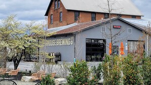 A building with a sign reading "HOUSE BREWING CO." and a sign above the entrance stating "OPEN TONIGHT." - A thoughtfully designed 3-bedroom, 2.5-bath townhome tailored for travelers. (Chambersburg)