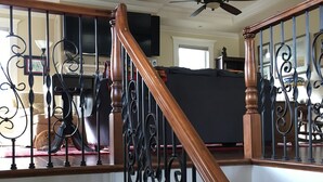A staircase with ornate black iron railings and wooden steps. - Fully Renovated 1905 Victorian in Historic Napa Neighborhood  (Napa)