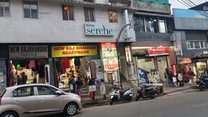 A street view with a hotel named 'Serehe' and various shops including 'New Rajbhandar Readymade' and 'Gadgetz'. - Hotel Serene (Shillong)