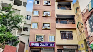 A multi-story building with a sign for "Hotel Quality Times" and a parking sign below. - Hotel Quality Time  (Udaipur)