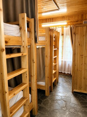 A wooden interior with bunk beds and a stone floor. - MT House Sa Pa (Sa Pa)
