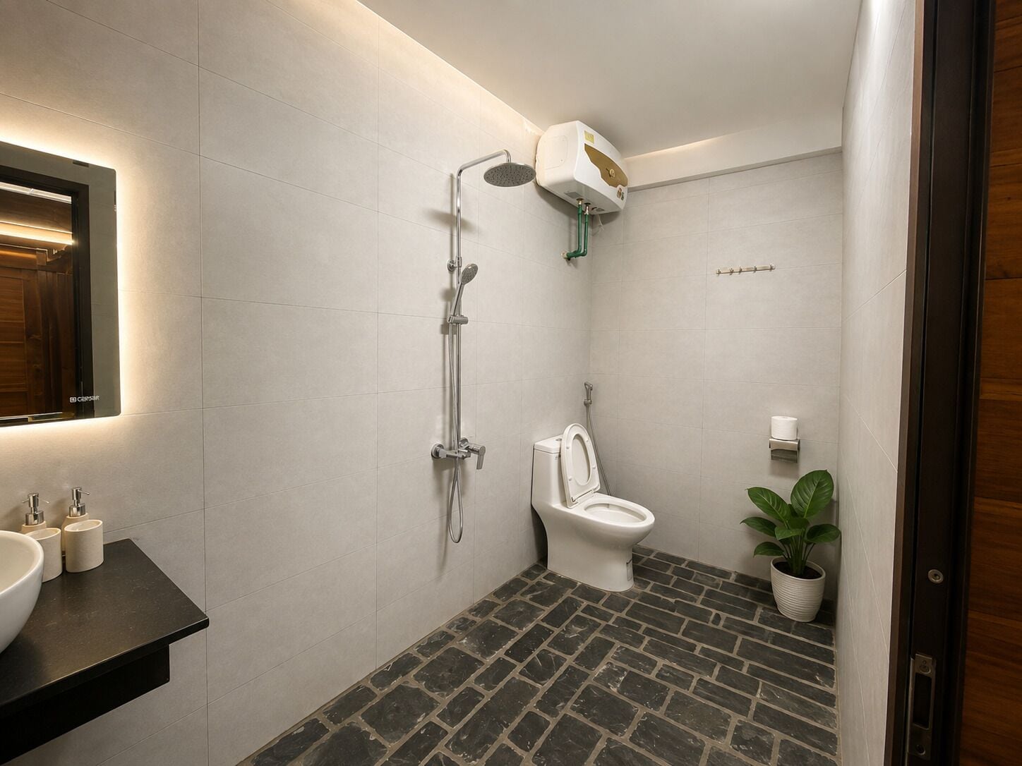 A modern bathroom with a shower, toilet, and sink.