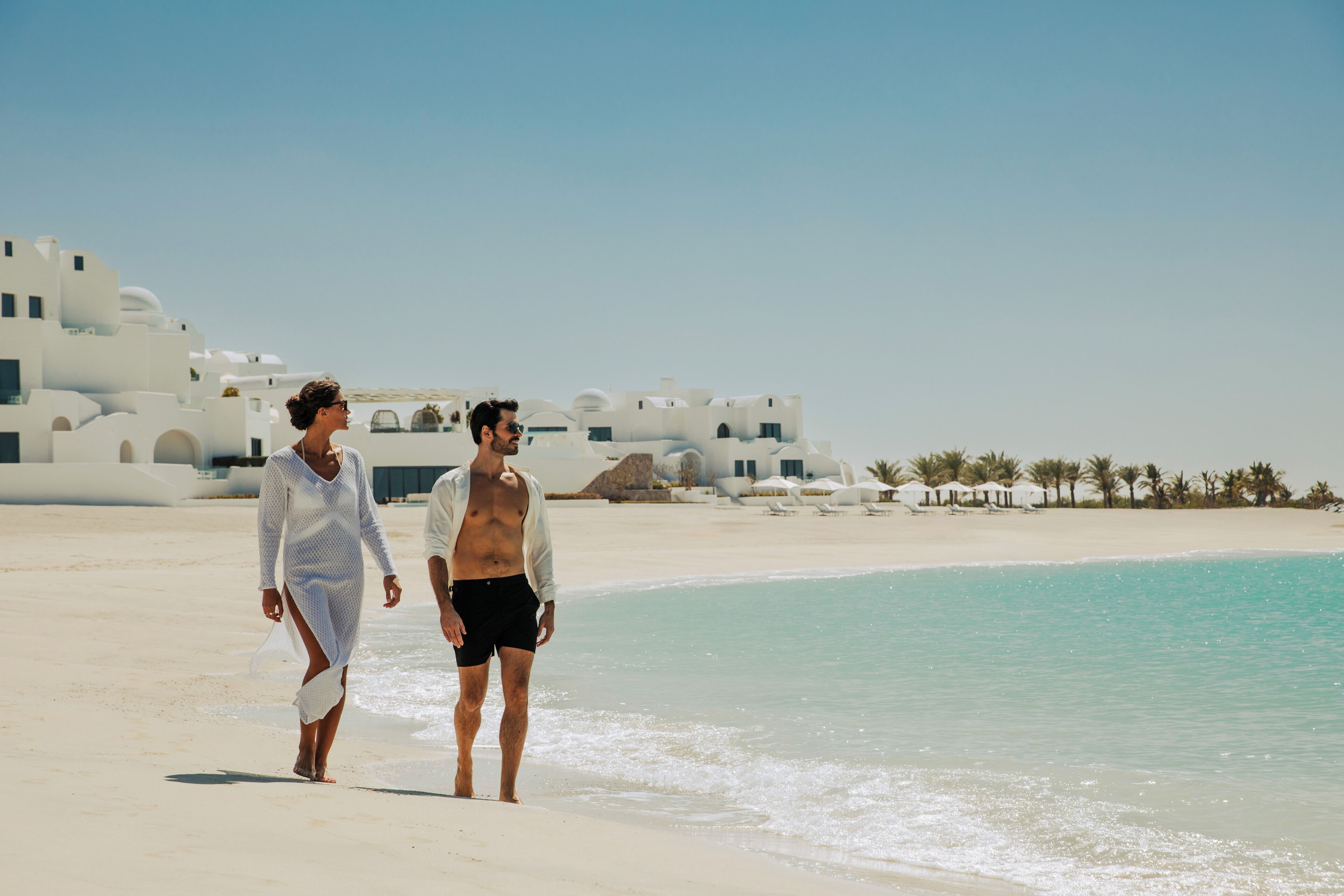 On the beach, white sand, beach umbrellas, beach towels