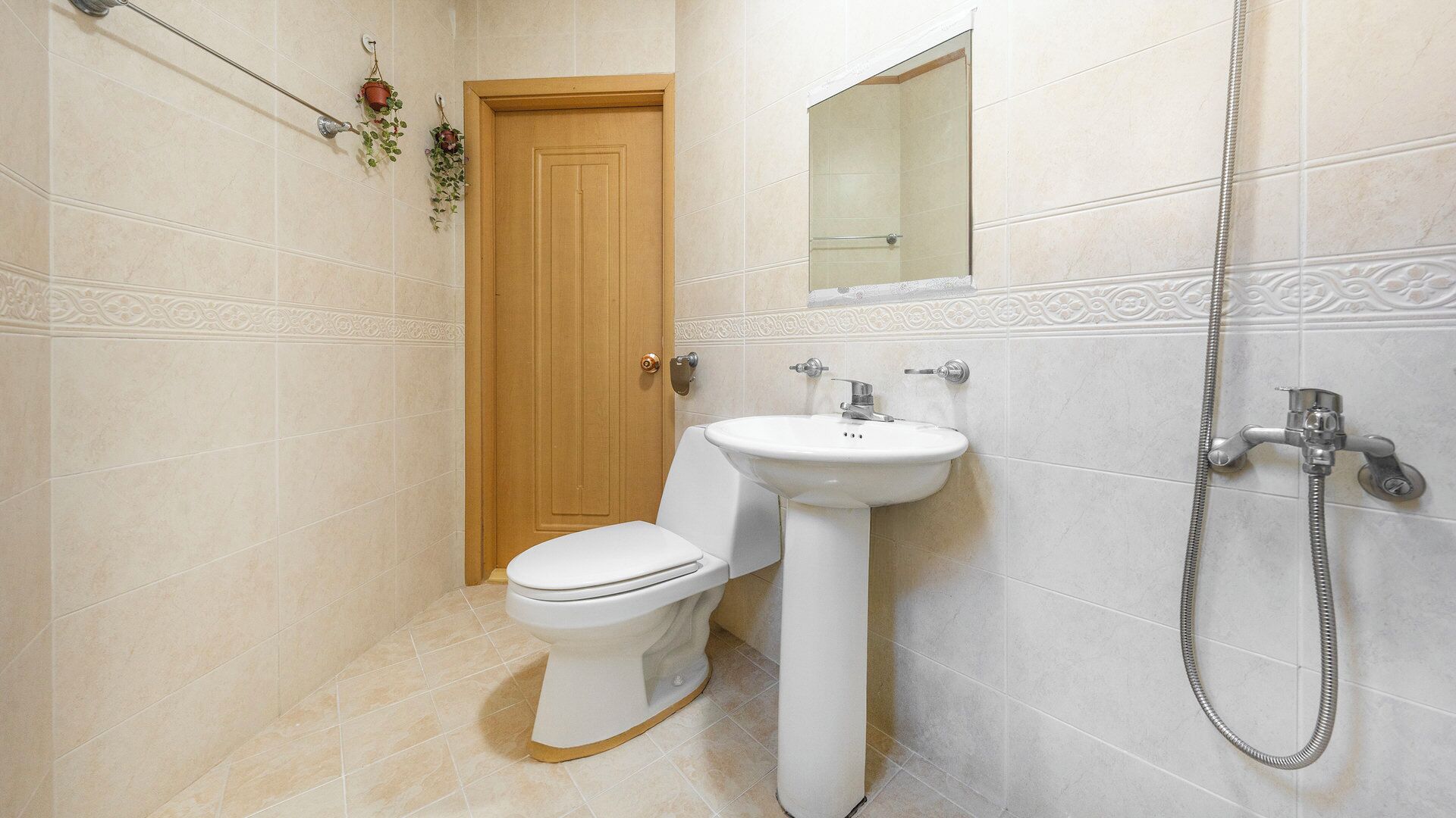 A bathroom with a toilet, sink, and shower.