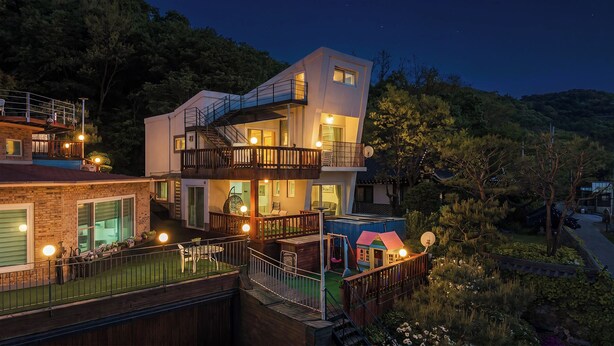 Un immeuble résidentiel à plusieurs étages doté d’un balcon, d’une piscine et d’un jardin.