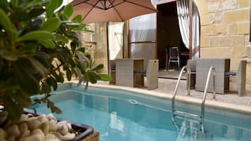 Seasonal outdoor pool, open 10:30 AM to 9:30 PM, pool umbrellas