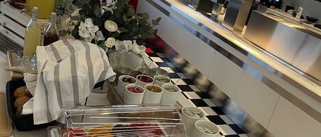 A buffet setup with various food items and beverages.