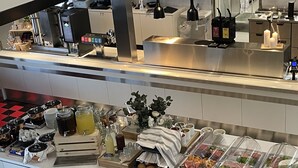 A buffet setup with various food items and condiments.