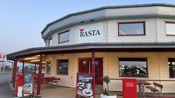 RASTA restaurant offers outdoor seating with benches and tables.