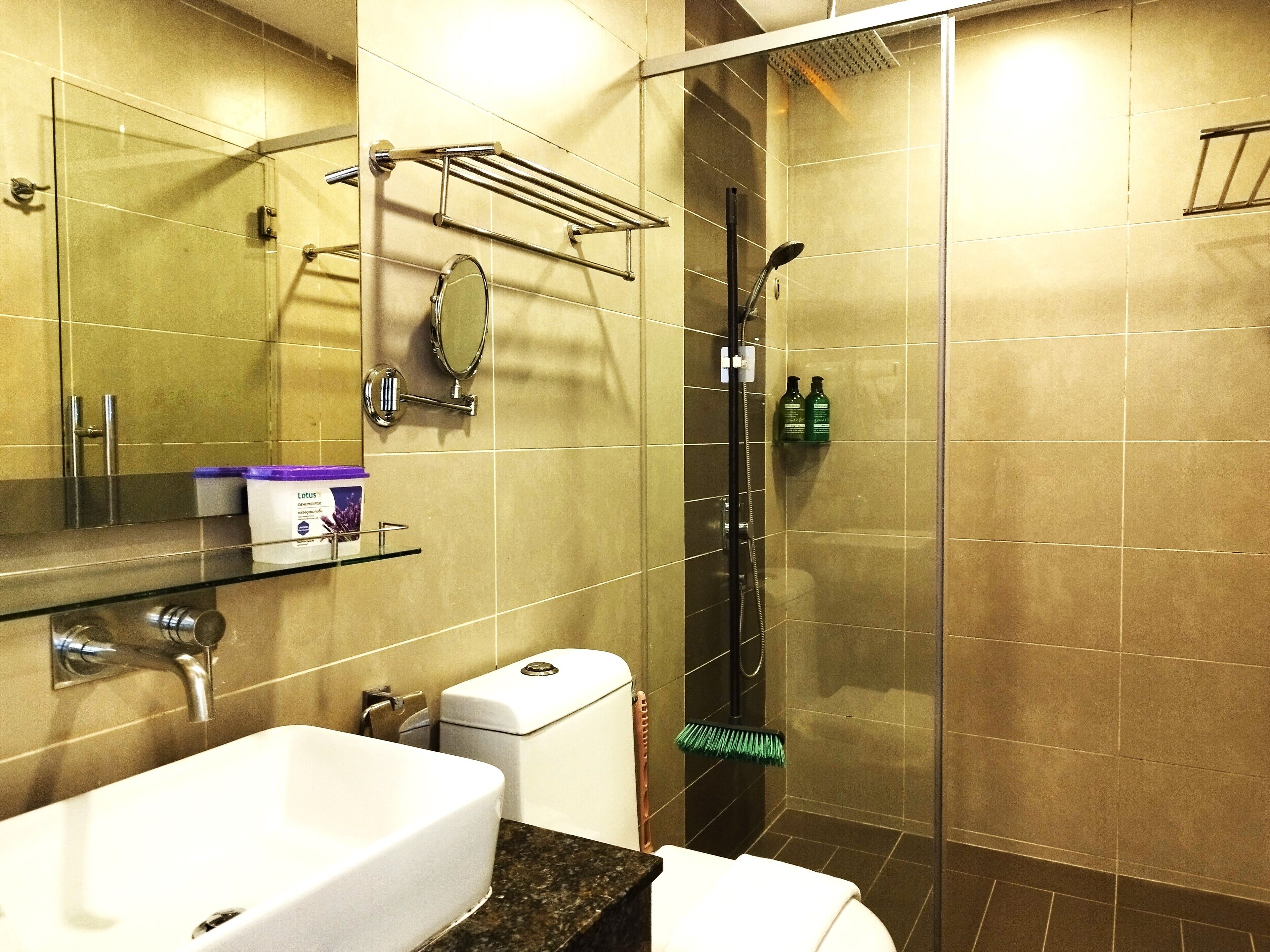 A bathroom with a sink, toilet, and shower.
