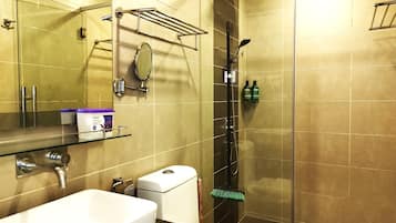 A bathroom with a sink, toilet, and shower.
