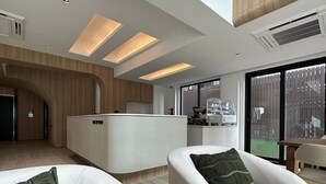 A modern interior with a reception desk, seating area, and large windows. - Jace Ratchada Hotel (Bangkok)