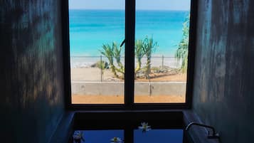 Luxury Studio Suite, 1 King Bed, Ocean View, Oceanfront | Bathroom | Combined shower/bathtub, rainfall showerhead, hair dryer, bathrobes