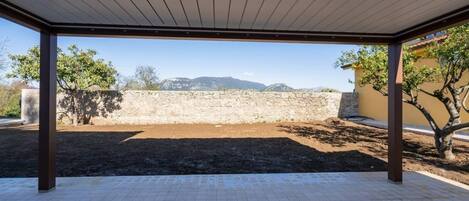 An outdoor patio area with a view of a mountainous landscape.