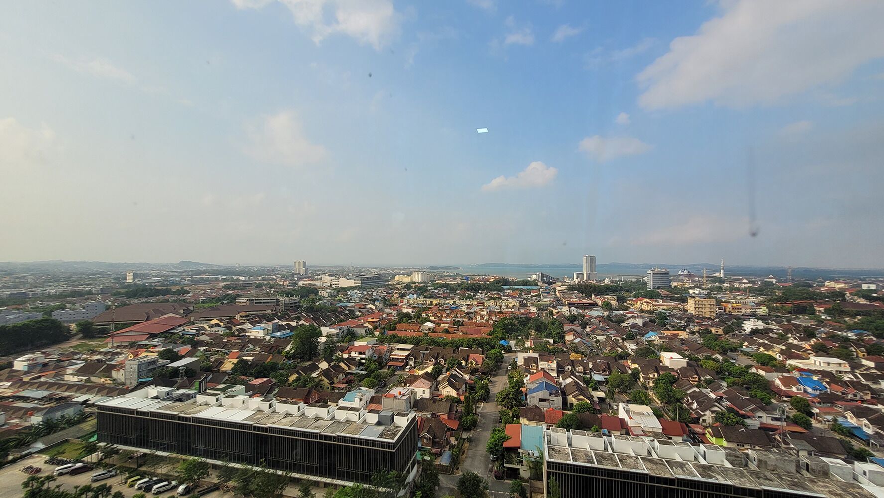 An aerial view of a densely populated urban area with various buildings, including residential and commercial structures.