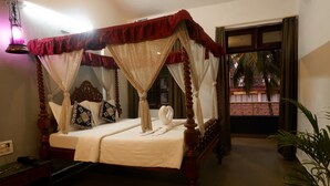 A four-poster bed with a canopy, a bedside table, and a nightstand. - Falcon Resorts by Dia Hotels (Calangute)