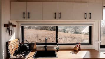 Fridge, stovetop, electric kettle, cookware/dishes/utensils