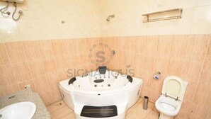 A bathroom with a bathtub, toilet, and sink.