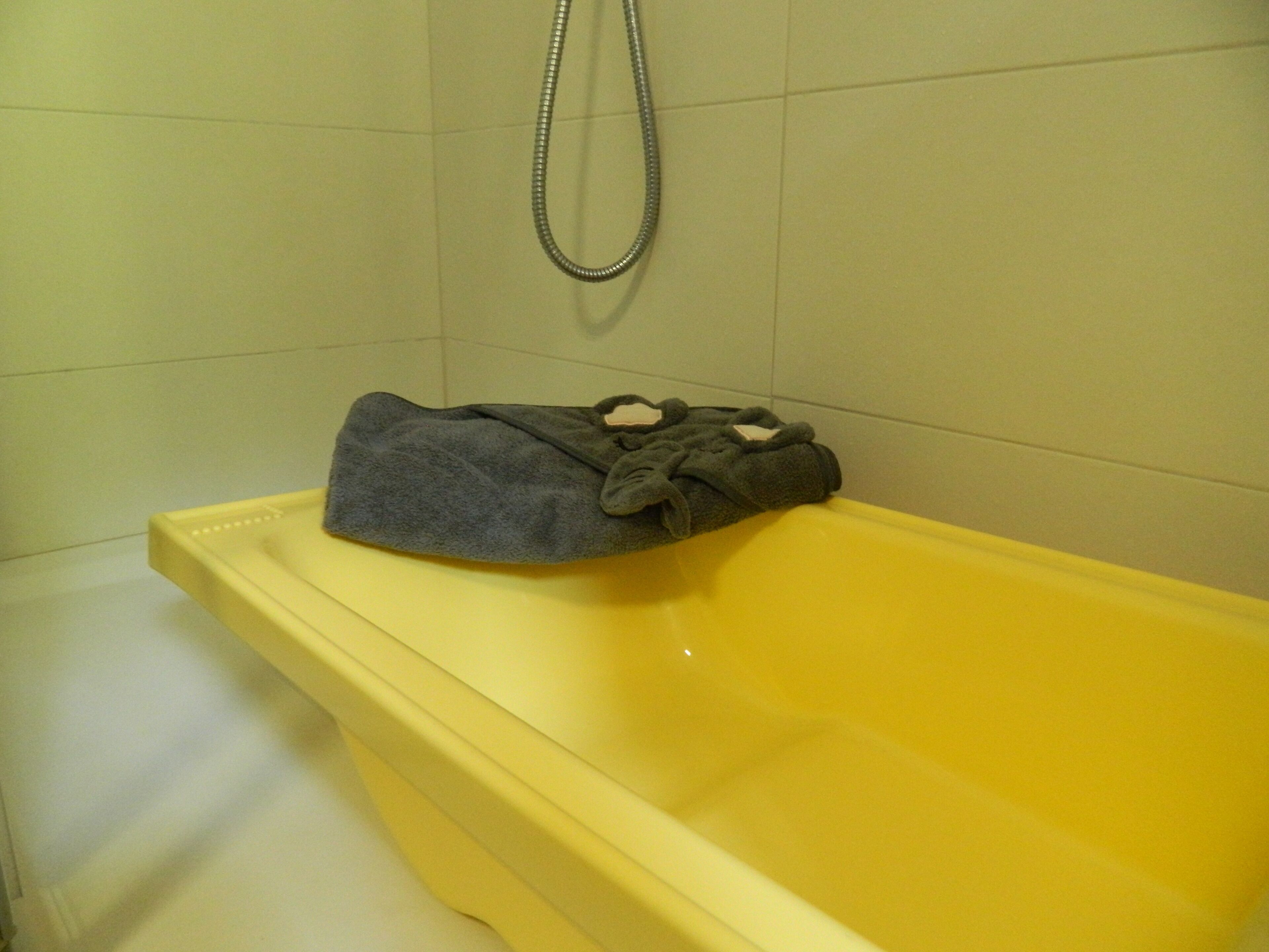 A bathtub with a towel on the edge.