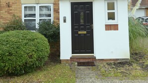 A two-story house with a white exterior, a black front door, and a small porch. - Gorgeous 3 bed in Bristol (Bradley Stoke)