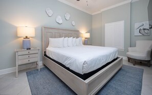Relax in a serene space with a large bed, bedside tables, and a comfortable chair.