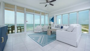 A spacious balcony with a white sofa, two armchairs, and a coffee table. - Phoenix Gulf Towers 901 4 Bedroom Condo (Orange Beach)