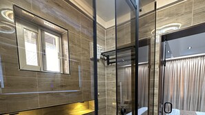 A modern bathroom with a glass shower enclosure, a built-in bench, and a large mirror. - Vika Luxury 3 Bedroom Serviced Apartment (Abuja)