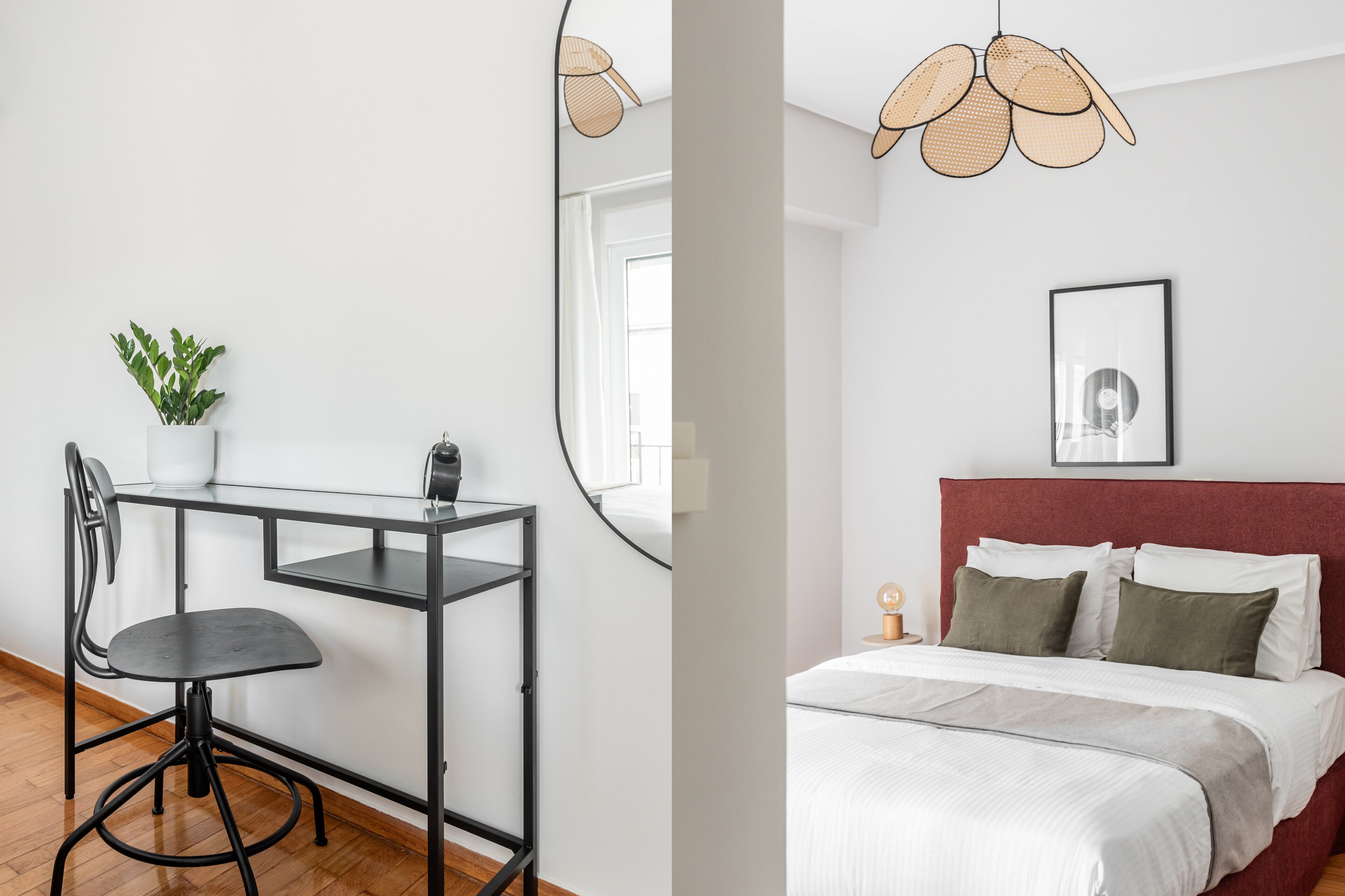 A room with a desk, chair, and a bed with a red headboard.