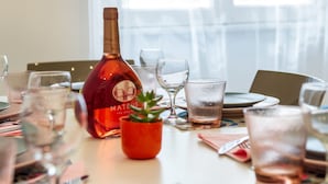 A dining table set with plates, glasses, and a bottle of Maté. - Apartment via Milizia 3br/3bt (Roma)