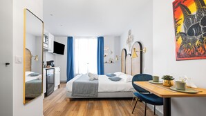 A modern hotel room with a bed, a desk, and a TV. - L'App-Art (Nice)